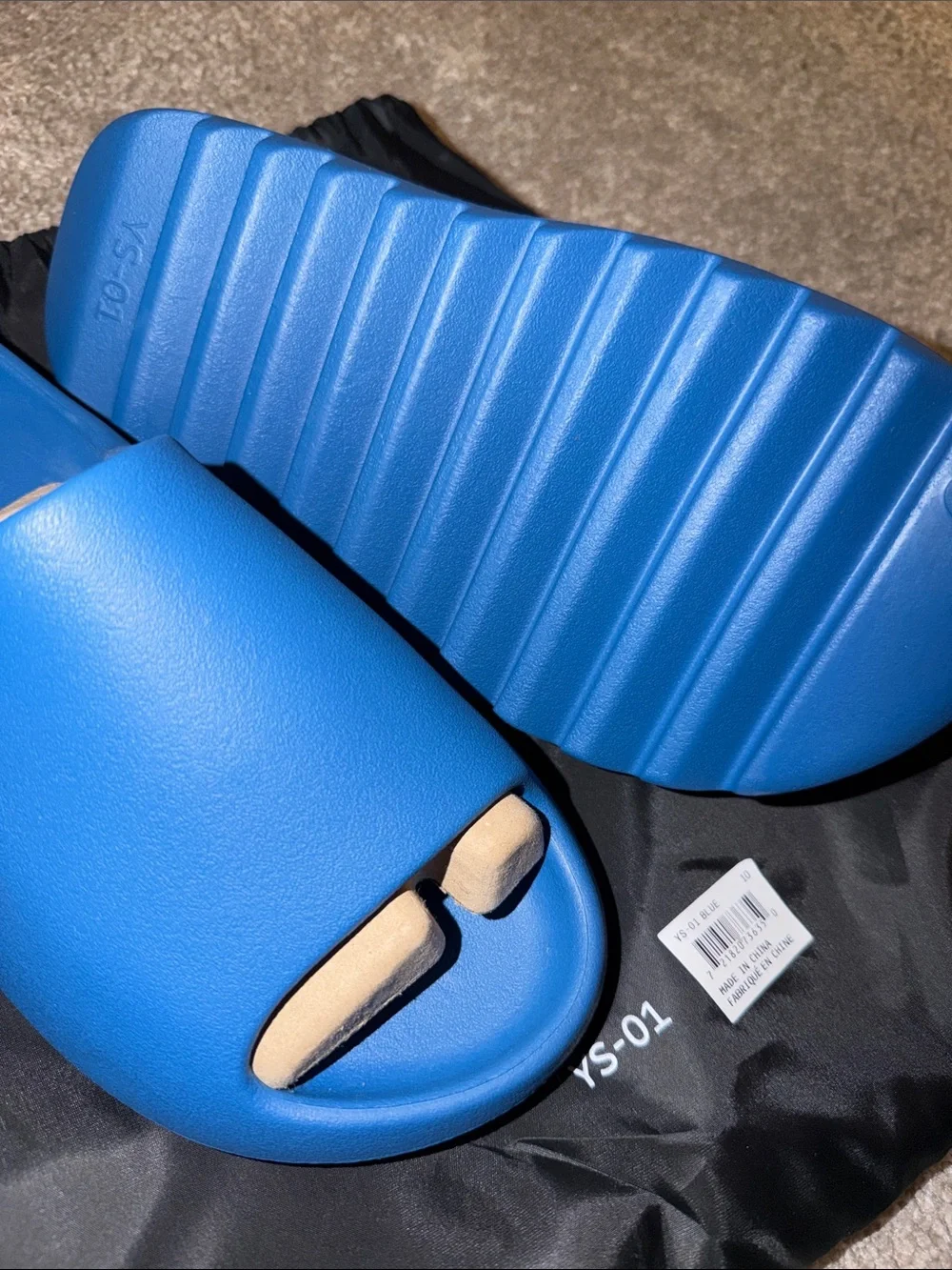 foam runner/slides inspired by Yeezy‎ designs. The bag says “YS-01,”